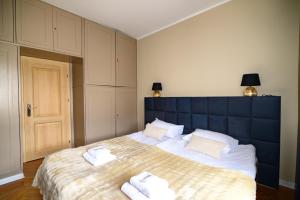 a bedroom with a large bed with towels on it at City Stay Kaszownik AC Progres in Toruń