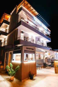 a building with a balcony on top of it at Zogaj Hotel in Ksamil
