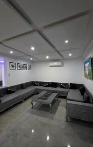 a large room with couches and a table in it at Luxury Prestige Villa in Midoun