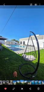 a swing hanging from a fence in a yard at Luxury Prestige Villa in Midoun