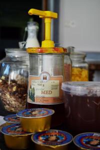 a bottle of mustard sitting next to containers of food at Rooms Jagoda I Cozy Alpine Stay Near Bled in Blejska Dobrava
