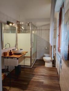a bathroom with a sink and a toilet and a shower at FalcoBianco GuestHouse in Montefalco +25 photos
