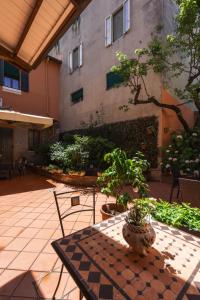 a patio with a table and chairs and a building at Gold Palace ***** in Ferrara