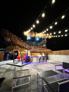 a stage with chairs and tables and lights at Stayhere Boracay Hostel in Boracay