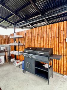 a grill in a room with a wooden wall at Stayhere Boracay Hostel in Boracay