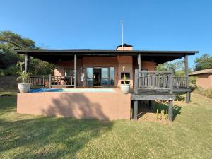 a small house with a porch and a yard at Sickle Bush Da Gama Lake in White River
