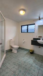 a bathroom with a toilet and a sink at Aroa Kainga Bungalows and Apartment in Rarotonga +55 photos