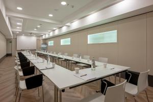 a conference room with a long table and chairs at UNA Hotels Galles Milano in Milan +99 photos