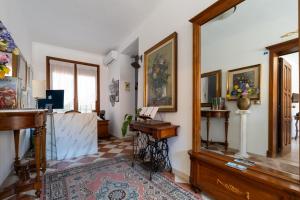 a living room with a piano and a desk at Gold Palace ***** in Ferrara