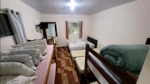 a room with several beds and a couch in it at Casa Benta in Aparecida +39 photos
