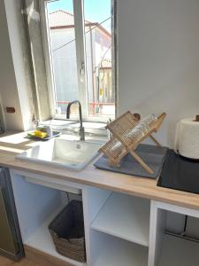 a kitchen counter with a sink and a window at Casa Bubela - Vía de la plata in Dozón