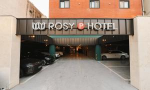 a parking garage with cars parked in it at Cheonan Asan Rosy Hotel in Asan
