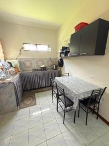 a kitchen with a table and chairs in a room at KRPV Homestay in Tambunan