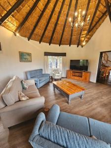 a living room with two couches and a coffee table at Pearse Farm Stay in Howick