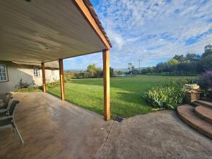 a covered patio with a view of a field at Pearse Farm Stay in Howick