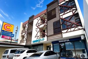 two cars parked in front of a building at Obrero Suites Davao in Davao City