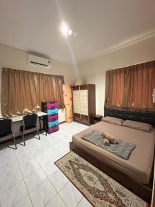 a bedroom with a bed with a teddy bear on it at KRPV Homestay in Tambunan