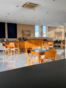a dining room with wooden tables and chairs at Hotel Pombeira in Guarda