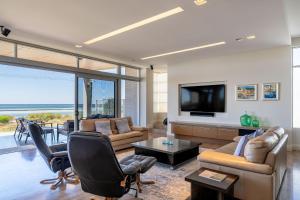 a living room with a tv and a couch and chairs at Number 10 I Private Properties in Dunsborough