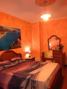 a bedroom with a bed and a dresser and a mirror at B&B Bella Vista in Dorgali