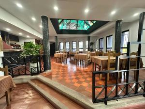 a restaurant with tables and chairs and a stained glass ceiling at Hotel Espor CA in Barinas