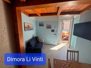 a living room with a blue couch in a room at Dimora Li Vinti in Cicciano