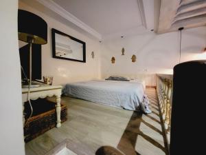 a bedroom with a bed and a table in it at Mediterranean Breeze Studio in Sidi Bou Saïd