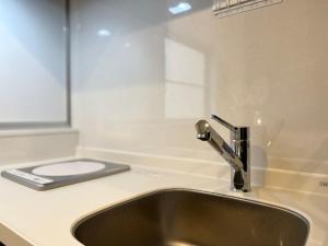 a kitchen sink with aaucet on a counter at Hotel Suite1 Quiet Family Stay Near Tokyo in Warabi +19 photos