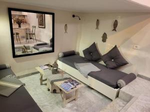 a living room with a couch and a table at Mediterranean Breeze Studio in Sidi Bou Saïd