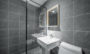 a bathroom with a sink and a toilet and a mirror at Pohang Villa Dahlia in Pohang +25 photos