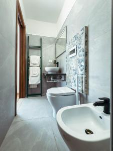 a bathroom with a white toilet and a sink at Gold Palace ***** in Ferrara +68 photos