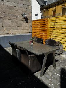 a table and chairs sitting on a patio at Mosel-Cottage-Appartment in Briedern