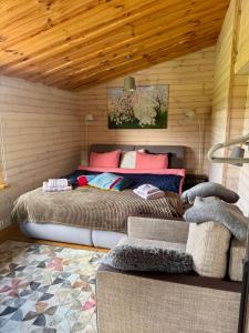 a bedroom with two beds in a room at Goldingen Stone Retreat - Hot Tub and Nature in Kuldīga