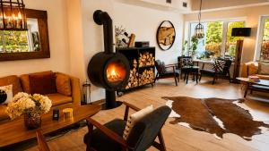 a living room with a wood stove in a room at Penzion Pibernik in Bled