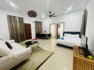 a living room with a bed and a couch at Ferringhi Beach Guesthouse-3bed in Batu Ferringhi