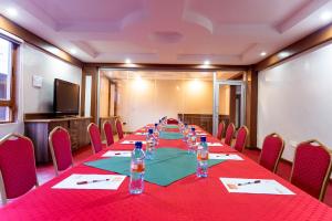 a conference room with a long table with chairs and water bottles at Lake Court Residence in Abuja