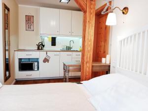 a bedroom with two beds and a kitchen at Penzion V peřině in Trojanovice
