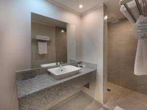 a bathroom with a sink and a mirror at ANEW Hotel Capital Pretoria in Pretoria +80 photos