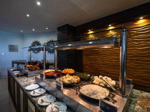 a buffet line with many different types of food at ANEW Hotel Capital Pretoria in Pretoria