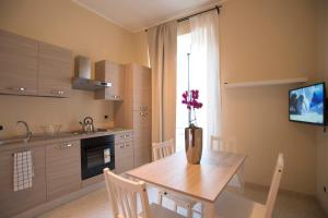 a kitchen with a table and a vase with flowers on it at Capital flat 9-A in Rome