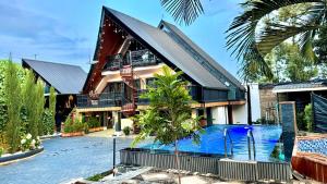 a house with a swimming pool in front of it at Fortunas Resort Nkubu, Meru in Nkubu