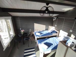 a room with two beds and a table and a window at Pakri lighthouse camping in Paldiski