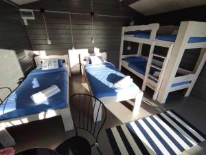 a room with two bunk beds and a table at Pakri lighthouse camping in Paldiski +14 photos
