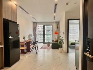 a living room with a kitchen and a dining room at 1BR Olive & Rouge House in Long Bình