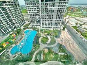 an aerial view of a pool in the middle of two tall buildings at 1BR Olive & Rouge House in Long Bình