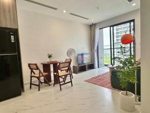 a living room with a table and chairs and a large window at 1BR Olive & Rouge House in Long Bình
