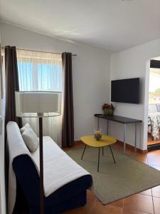 a living room with a couch and a table at Apartments Romano in Rovinj