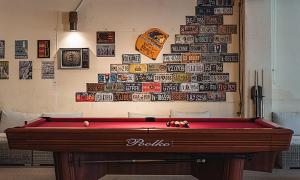 a pool table in front of a wall with stickers at Chuncheon Bali 376 in Chuncheon