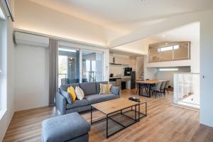 a living room with a couch and a table at YUTORELA 富津 with SAUNA プライベートサウナ完備 in Futtsu