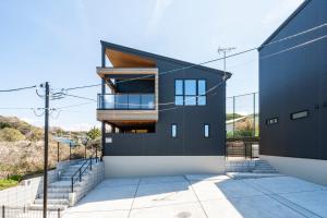 a modern house with a black facade at YUTORELA 富津 with SAUNA プライベートサウナ完備 in Futtsu